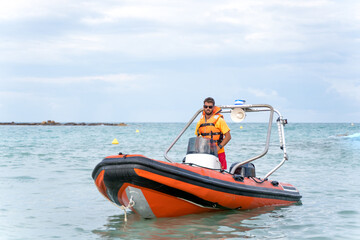 Lifeguard driving a boat in the middle of the sea