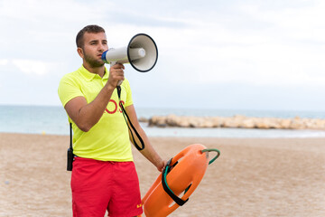 Lifeguard using a megaphone on the beach