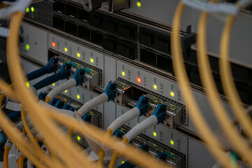 The main fiber optic channels are connected to the interfaces of a powerful router. Modern switching equipment is in the server room of the Internet data center.