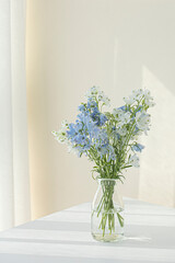 Blue delphiniums in a glass vase