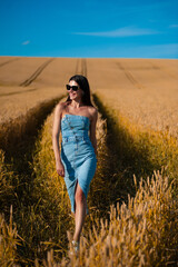 beautiful young woman in golden wheat field