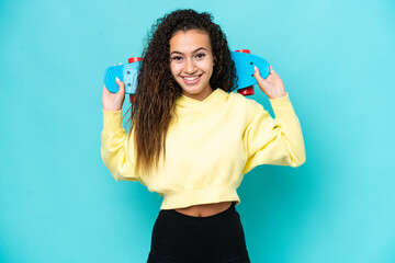 Fototapeta premium Young Arab woman isolated on blue background with a skate with happy expression