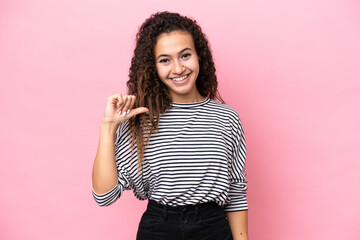 Young hispanic woman isolated on pink background proud and self-satisfied