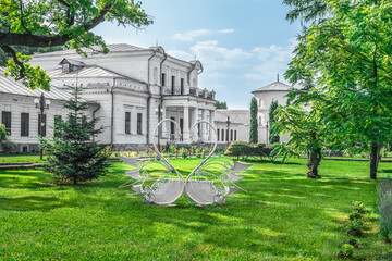 Trostyanets, Sumy Oblast, Ukraine - June 18, 2023: A pair of heart-shaped steel swans on the lawn in front of the Golitsyn Palace in Trostianets. Romantic decor on the Alley of lovers