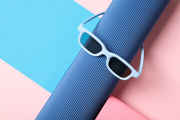 Blue sunglasses on blue and pink background, space for text