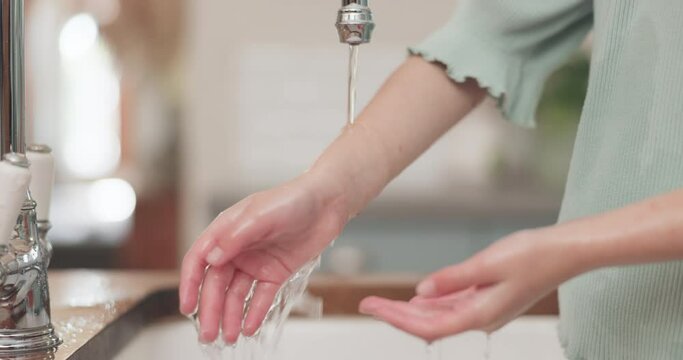 Washing hands, woman and water in home, foam and kitchen for hygiene, health or self care with faucet. Lady, tap and cleaning palm with soap for germs, virus or bacteria at sink for wellness in house