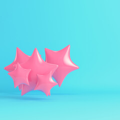 Flying pink stars on bright blue background in pastel colors. Minimalism concept