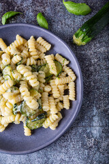 Fusilli pasta with zucchini and goat cheese cream. Healthy, balanced and nutritious vegetarian dish.