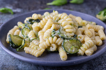 Fusilli pasta with zucchini and goat cheese cream. Healthy, balanced and nutritious vegetarian dish.