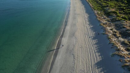Couple walking along Woodman Point Beach, Perth City suburbs in Western Australia. Aerial drone view