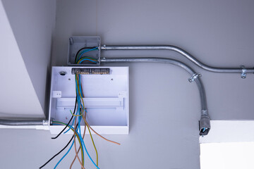 An empty electrical control box in the house. Opened electrical plastic control box with wires and...