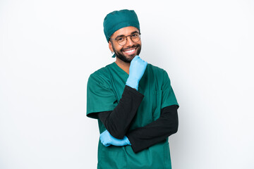 Surgeon Brazilian man in green uniform isolated on white background with glasses and smiling