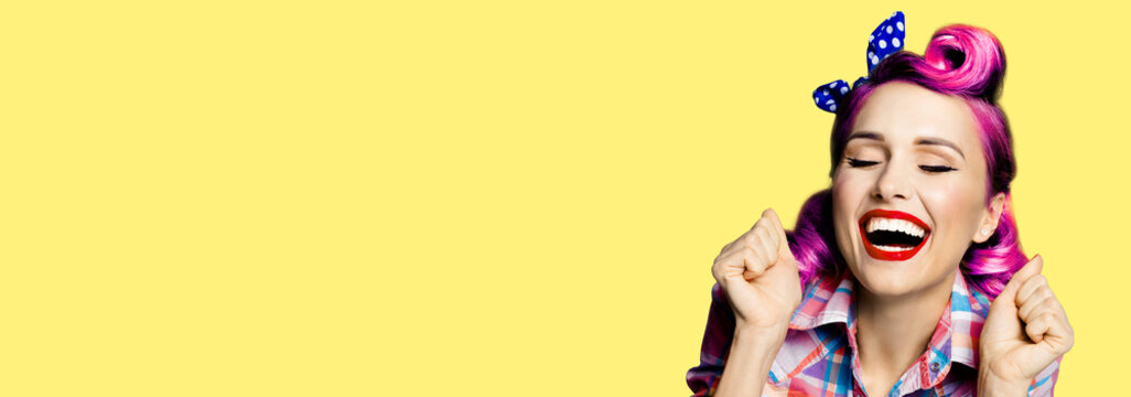Unbelievable news! Excited surprised, very happy purple woman. Pin up girl with open mouth and closed eyes with raised hands. Retro and vintage concept. Yellow background. Wide composition image.