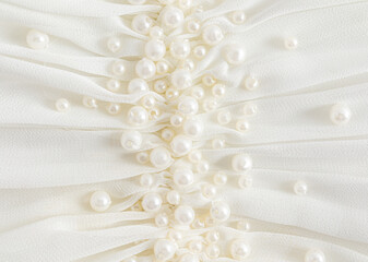 A large type of embroidery with pearl beads on a dress of beige, ivory, champagne. soft waves of...