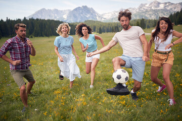 Group of people playing with ball. sport outdoors of a group of friends having fun playing soccer...