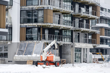 modern house with premium apartments and construction equipment in winter