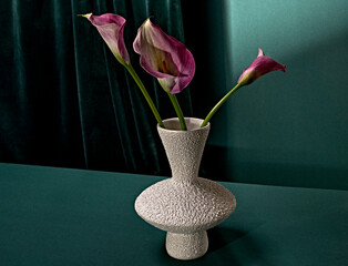 pink flower in white vase green background 