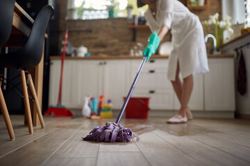 The Master of Clean: A Woman's Commanding Presence with Mop and Bucket