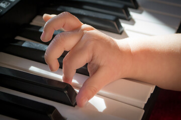 kid trying to play the synthesizer