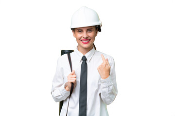 Young architect woman with helmet and holding blueprints over isolated background giving a thumbs up gesture