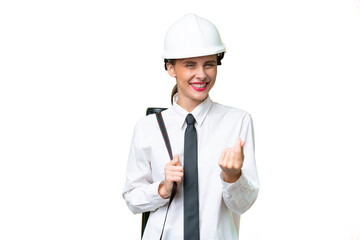 Young architect woman with helmet and holding blueprints over isolated background making money gesture