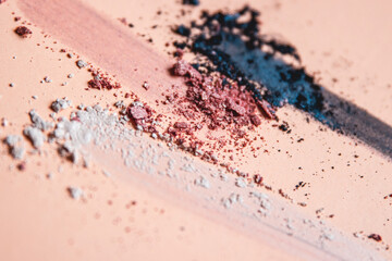 Fototapeta na wymiar Loose Crumbled Shimmer Eyeshadow Artistic Arrangement Teal, Pink and White on a Nude Shaded Background