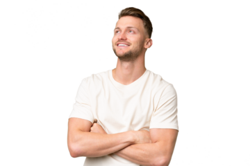 Young blonde caucasian man over isolated background looking up while smiling