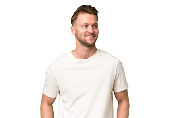 Fototapeta premium Young blonde caucasian man over isolated background thinking an idea while looking up
