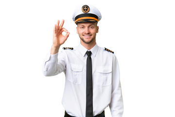 Airplane pilot man over isolated background showing ok sign with fingers