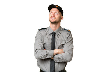 Young security caucasian man over isolated background looking up while smiling