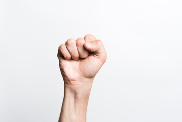 Close-up of a man's clenched fist on a white background.