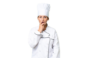 Middle-aged chef woman over isolated background surprised and shocked while looking right