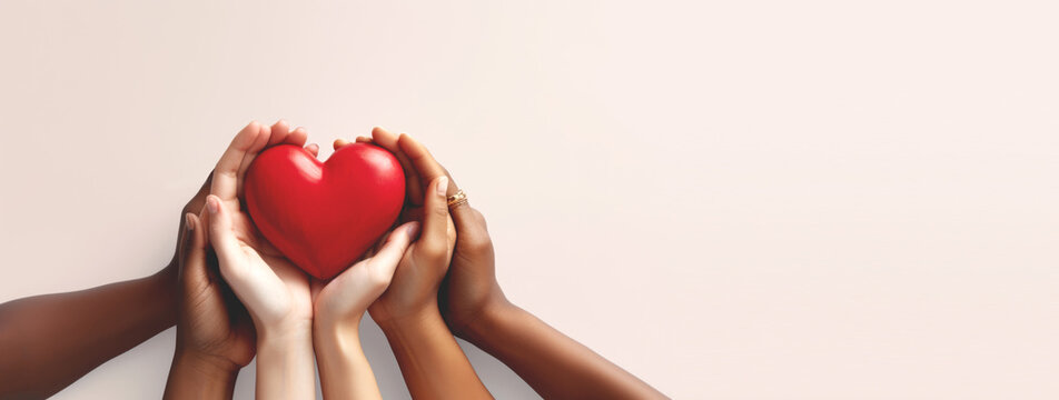 Many hands hold red heart , charity and helping concept