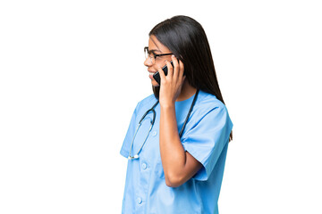 Young African american nurse woman over isolated background keeping a conversation with the mobile phone with someone