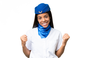 Airplane stewardess African american woman over isolated background celebrating a victory in winner position