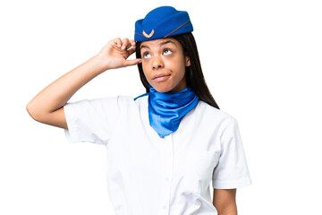 Airplane stewardess African american woman over isolated background having doubts and with confuse...