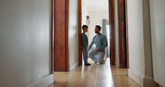 Measure, growth and dad writing on wall with child in family home, door frame and measuring height, measurement or progress results. Father, pride in son and check development together in a house