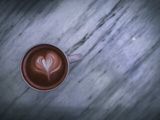 Hot latte art coffee cup on marble table