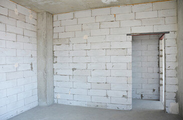 New apartment with aerated concrete blocks walls, concrete ceiling, column and doorway in a new...