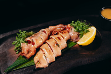 Stuffed meat cut with lemon the black plate