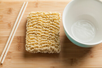 Ramen noodles on the table with a bowl and chopsticks. Ramen concept. Asian food concept.