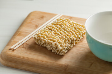 Ramen noodles on the table with a bowl and chopsticks. Ramen concept. Asian food concept.