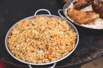 Food festival with food stall kiosk, open-air outdoor fair market, assortment of different traditional European grilled barbecued street food with sausages, bbq, chicken, pork and lamb on a large pan