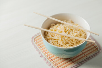 Ramen noodles in a bowl and chopsticks. Ramen concept. Noodle concept.