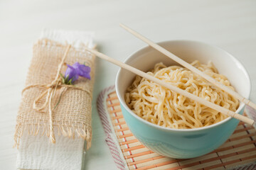 Ramen noodles in a bowl and chopsticks. Ramen concept. Noodle concept.
