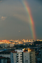 Naklejka na ściany i meble AirPlane passing by a Rainbow, 