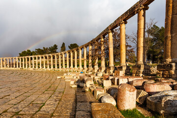 Fototapeta na wymiar Rainbow above the oval Forum of Gerasa, Jerash, Jordan, Middle East