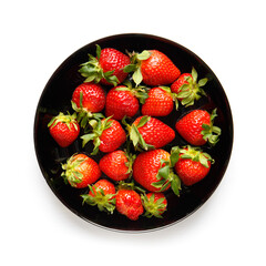 Berries of organic strawberries in a black round plate isolated on white background, top view.