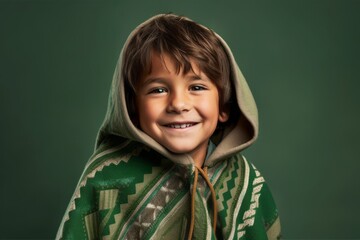 Headshot portrait photography of a glad kid male wearing a unique poncho against a green background. With generative AI technology