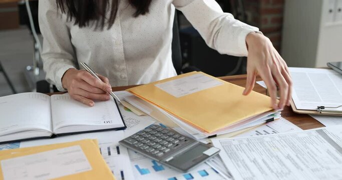 Woman secretary sorting post letters at table in office closeup 4k movie. Postal communication concept
